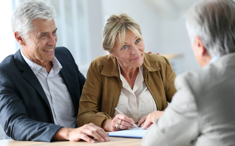 Senior couple meeting real-estate agent for investment